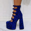 Black patent leather women's platform high heel boots with a thick heel and serpentine ankle buckle