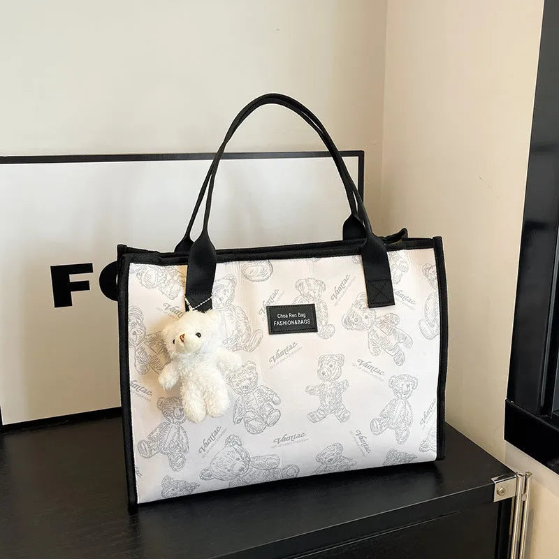 Women's black canvas tote bag with rhombus pattern print and shoulder strap