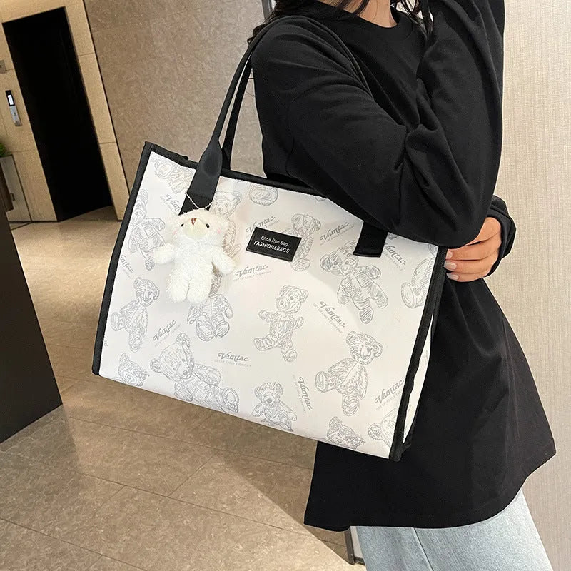 Women's black canvas tote bag with rhombus pattern print and shoulder strap