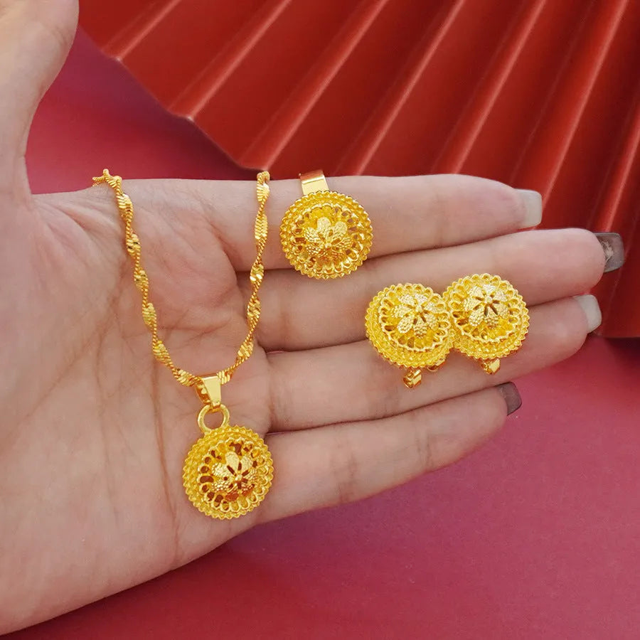Gold-plated three-piece jewellery set with necklace, earrings, and ring in a floral design.
