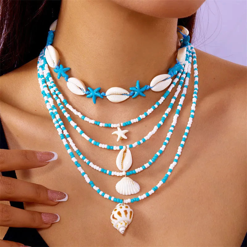 Women's multi-layer necklace set with blue shell pendants and beads, showing five coordinated designs