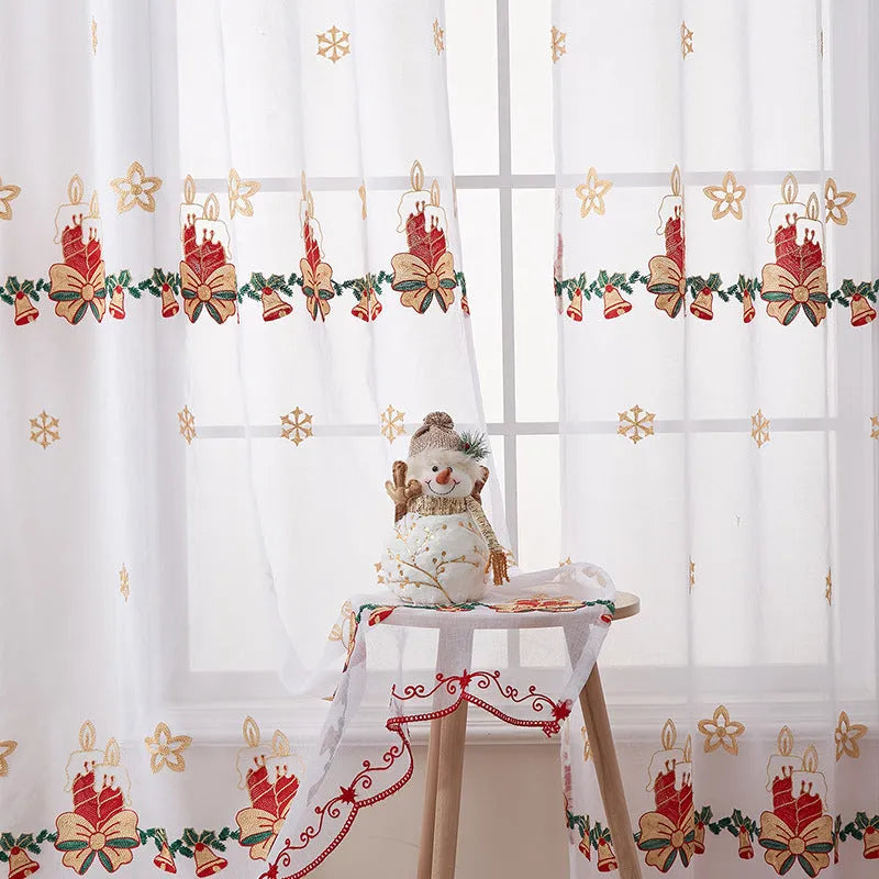 A pair of white polyester curtains with embroidered red and green snowflakes, showing American Christmas style.