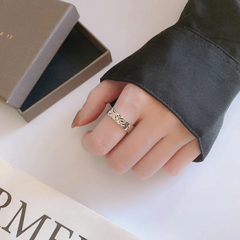 Geometric adjustable ring in matte black copper with round and oval design elements