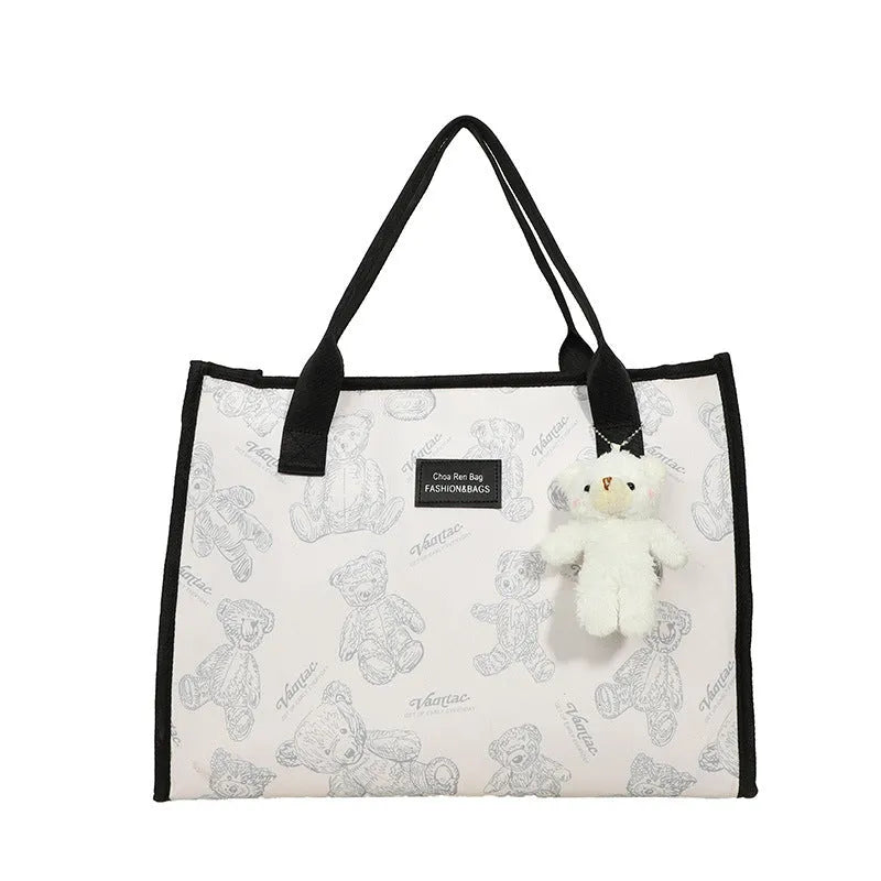 Women's black canvas tote bag with rhombus pattern print and shoulder strap