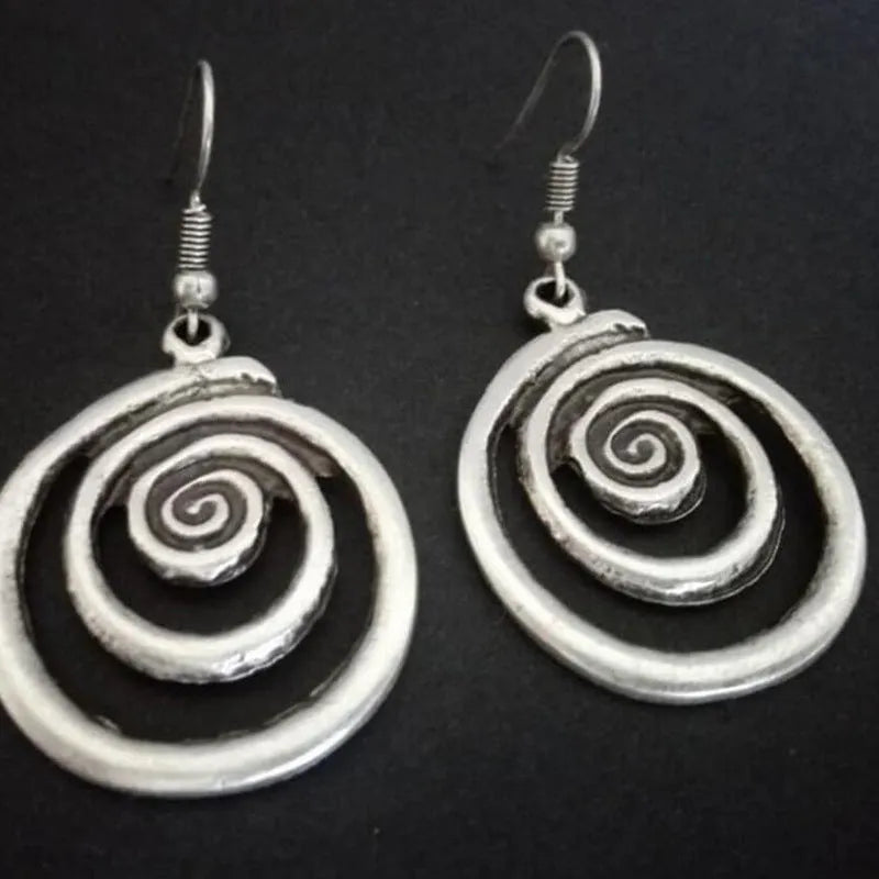 Silver geometric spiral distressed earrings showing alloy construction and 5cm drop length