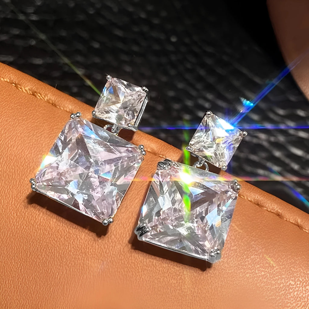 A pair of geometric square copper earrings with a quadrilateral design, shown in white gold and gold colour options.