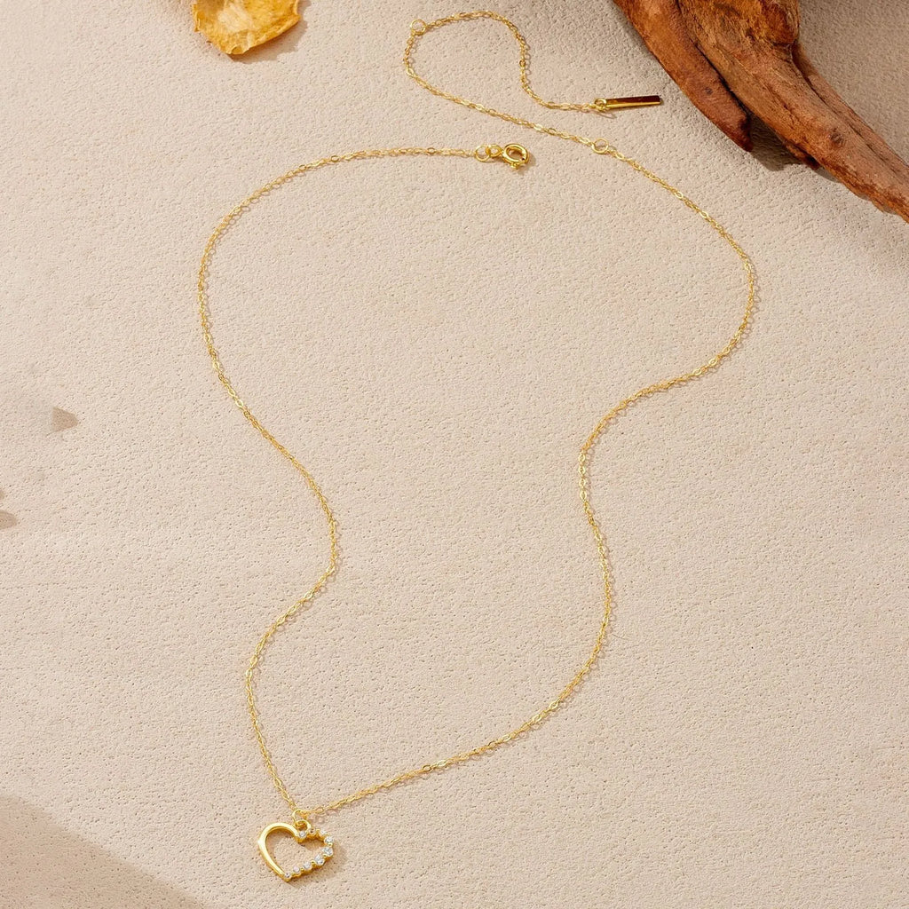 Sterling silver hollow heart necklace with circular details on a regular chain