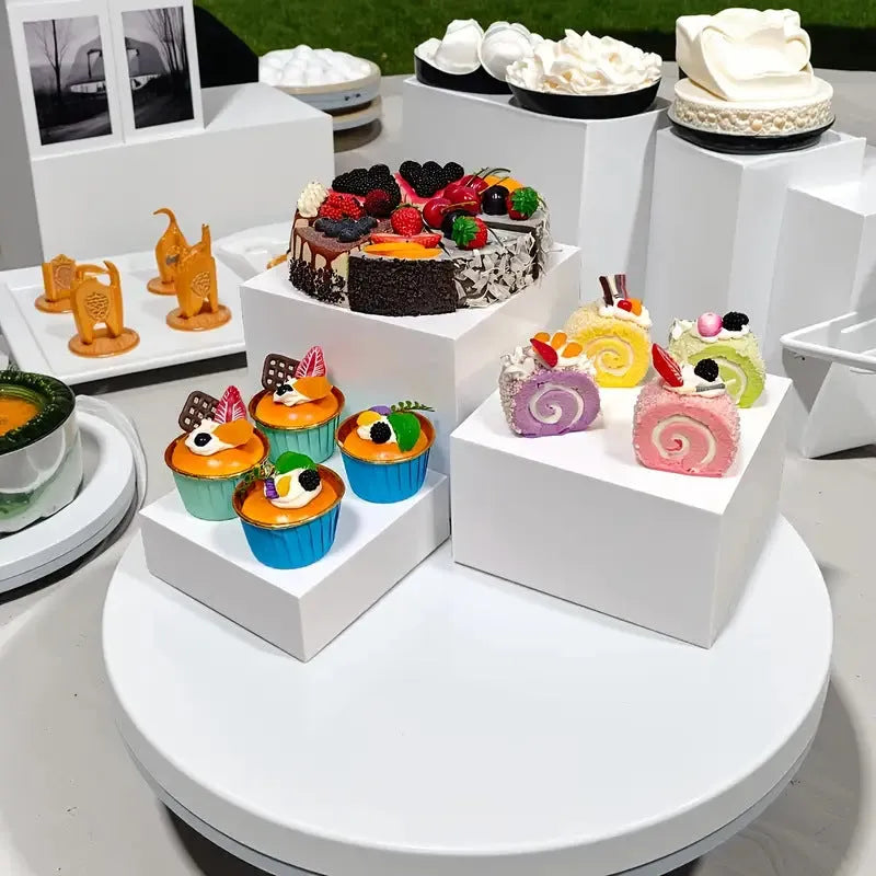 White plastic six-piece suit cube desktop dessert display stand set arranged in tiers.