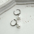 Pair of pearl-coloured geometric round drop earrings made from titanium steel alloy