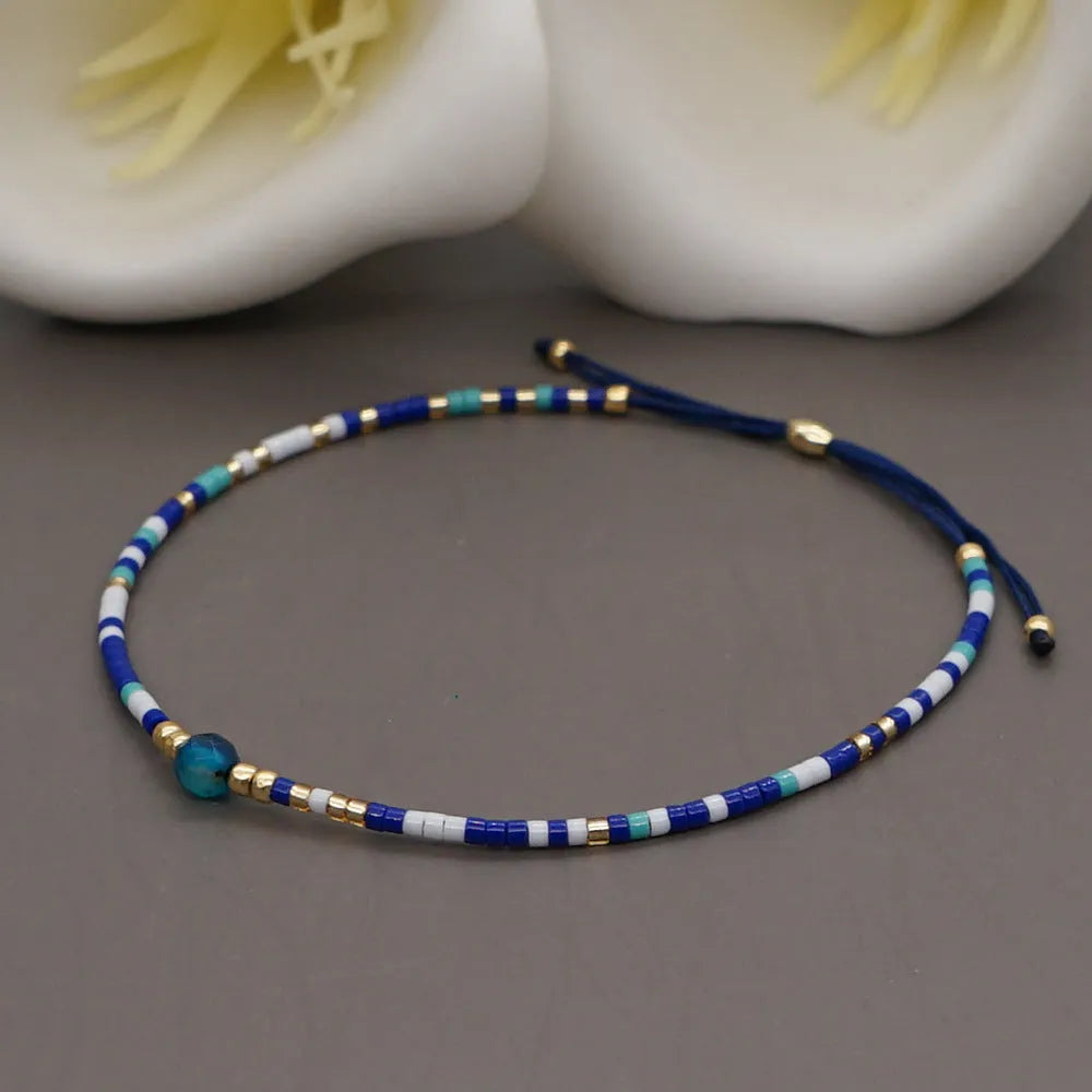 A colourful Bohemian style beaded bracelet with semi-precious stone and glass beads on an adjustable strap.