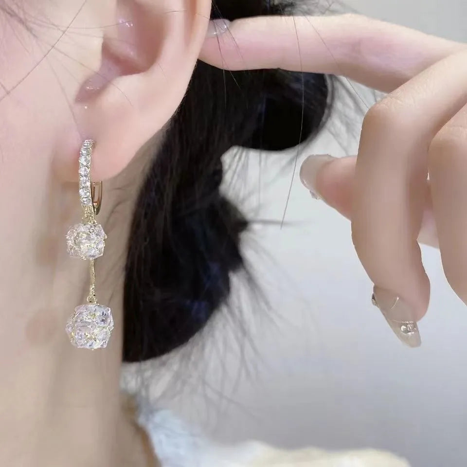 Silver tone clip-on earrings with tassel ball and rhinestone ball pendants in drop design