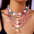 Women's multi-layer necklace set with blue shell pendants and beads, showing five coordinated designs