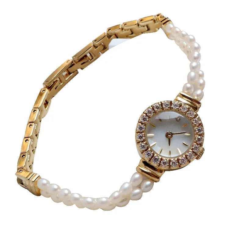 Women's light gold bracelet watch with freshwater pearls, round mineral glass dial, and stainless steel folding buckle