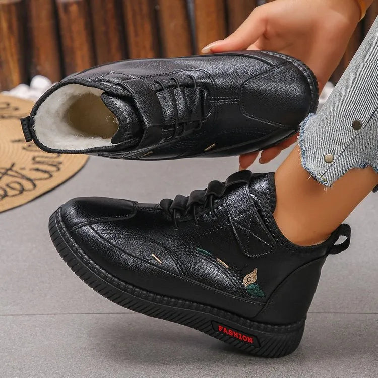 Black women's velvet slipper with non-slip rubber sole and hollow out design