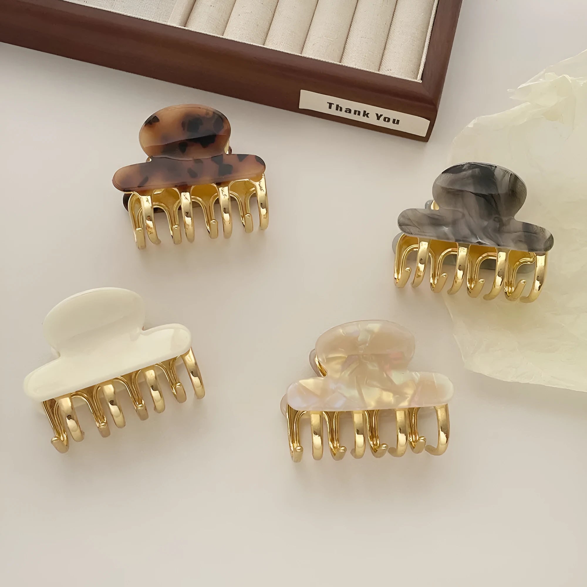 A medium-size retro-style hair barrette with a metal grip, in an alloy acrylic construction.