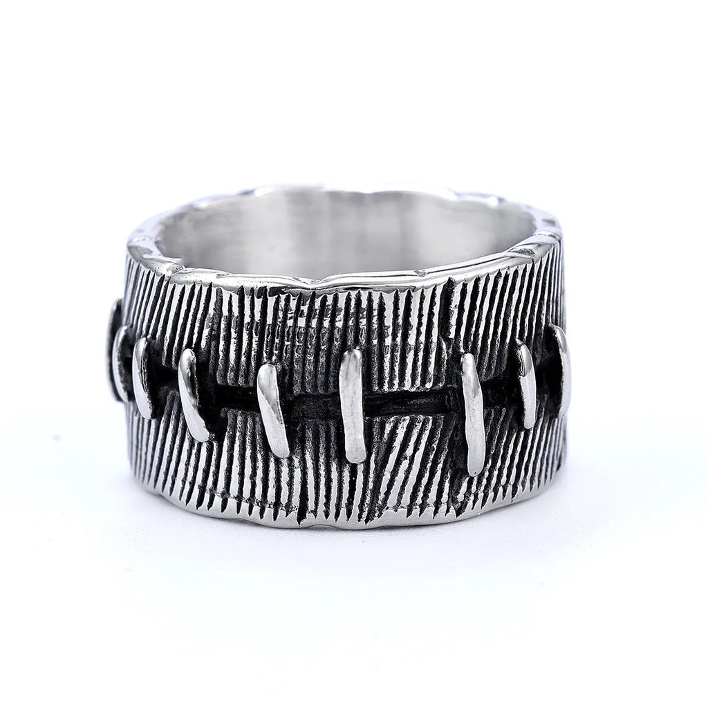 Geometric dark punk titanium steel double ring in retro colour, showing stitched design on a hand.