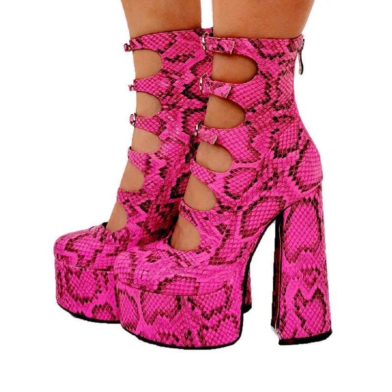 Black patent leather women's platform high heel boots with a thick heel and serpentine ankle buckle