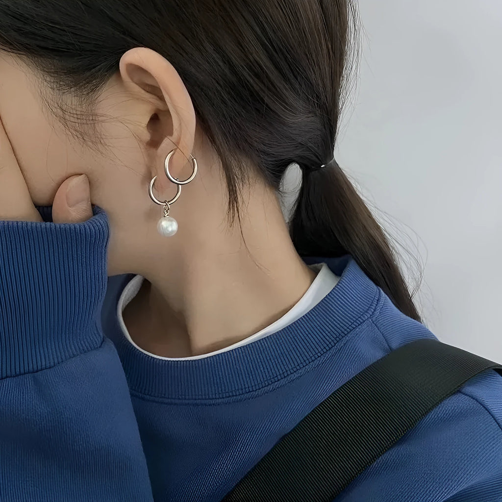 Pair of pearl-coloured geometric round drop earrings made from titanium steel alloy