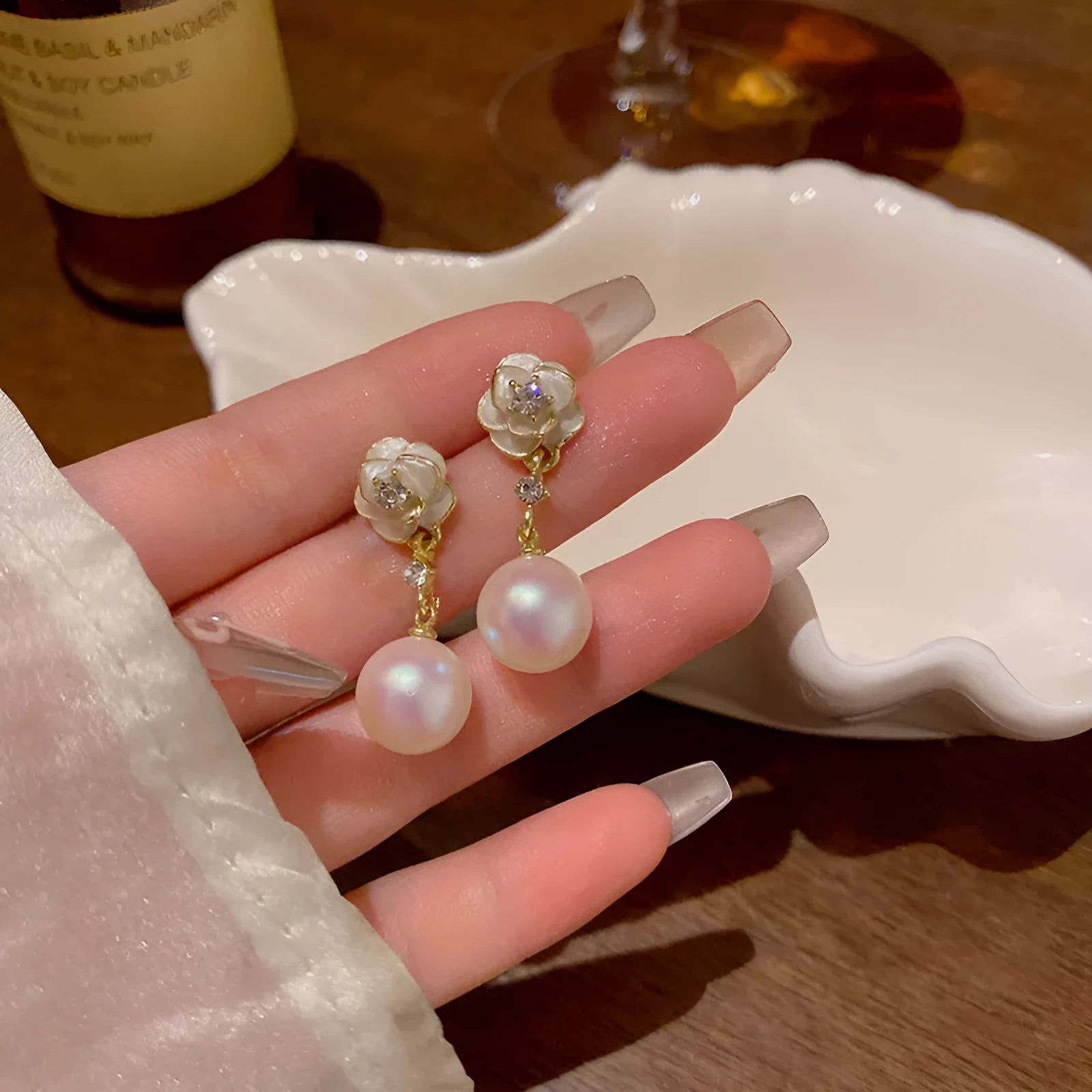 Camellia flower shaped stud earrings in alloy metal with floral design details