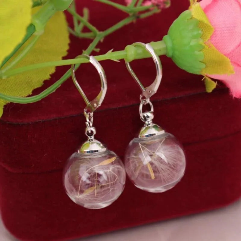 Transparent glass ball earrings with dandelion seed crystal design in silver and bronze finishes