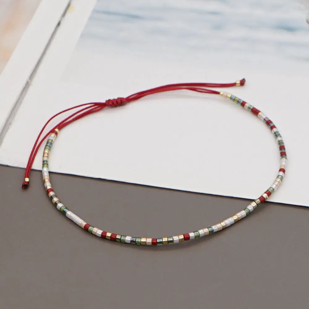 A colourful Bohemian style beaded bracelet with semi-precious stone and glass beads on an adjustable strap.
