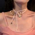 Women's alloy love pendant necklace with ribbon detail on a clavicle chain, electroplated finish.
