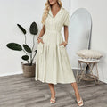 Light green women's shirt dress with lapel collar, waist tie, and skirt pocket on a hanger.