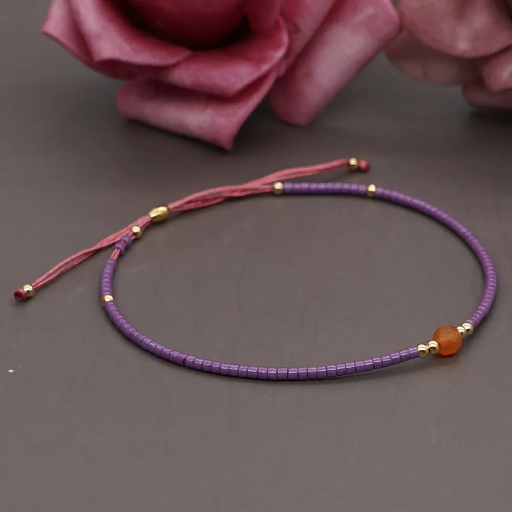 A colourful Bohemian style beaded bracelet with semi-precious stone and glass beads on an adjustable strap.