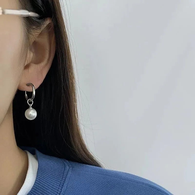 Pair of pearl-coloured geometric round drop earrings made from titanium steel alloy