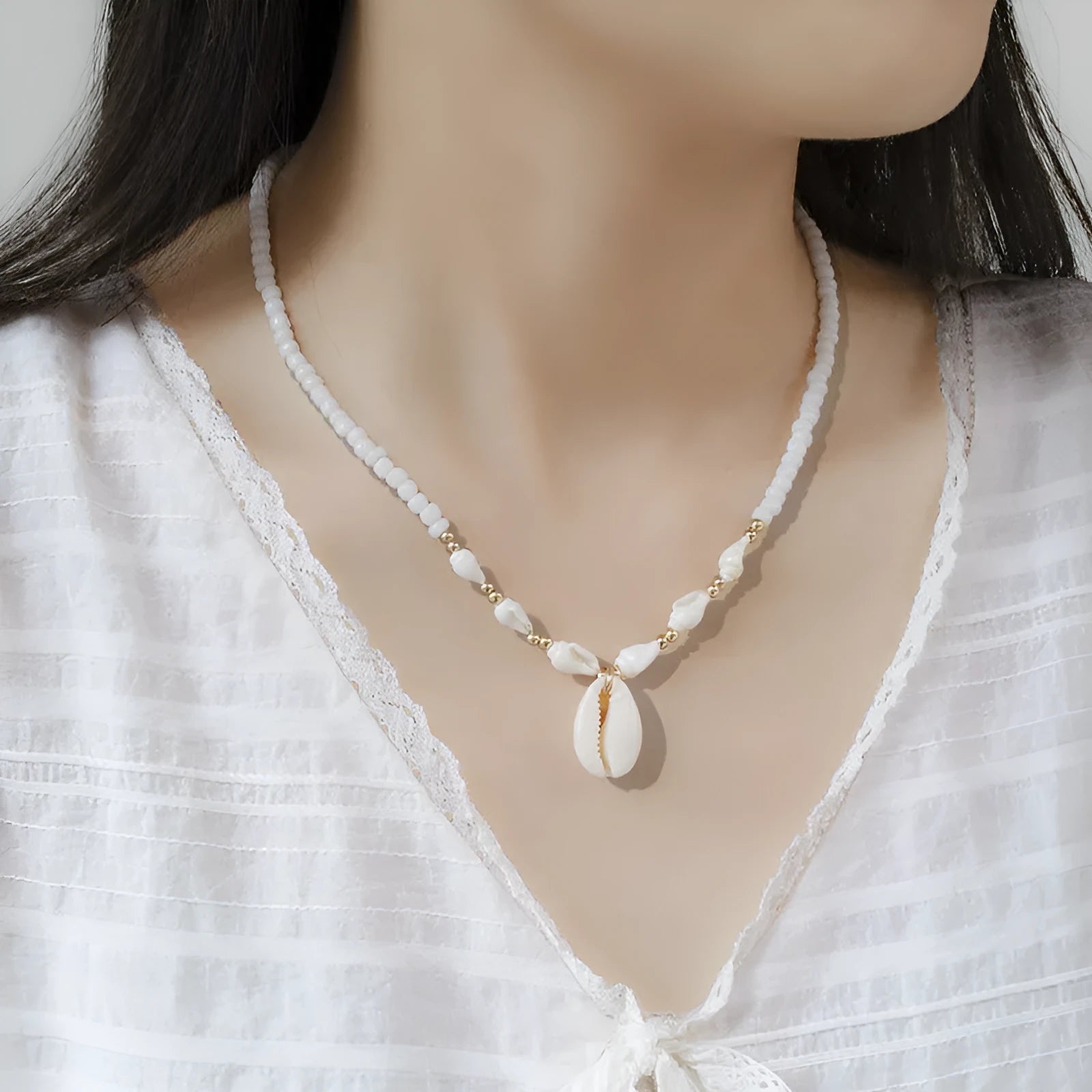 Women's white mother of pearl shell pendant necklace with regular chain on display