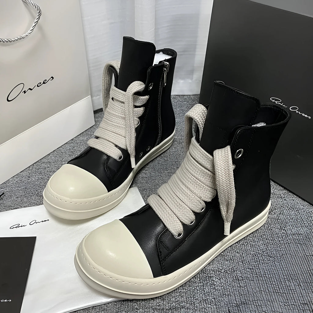 Men's black high-top leather sneakers with a side zip on a white background