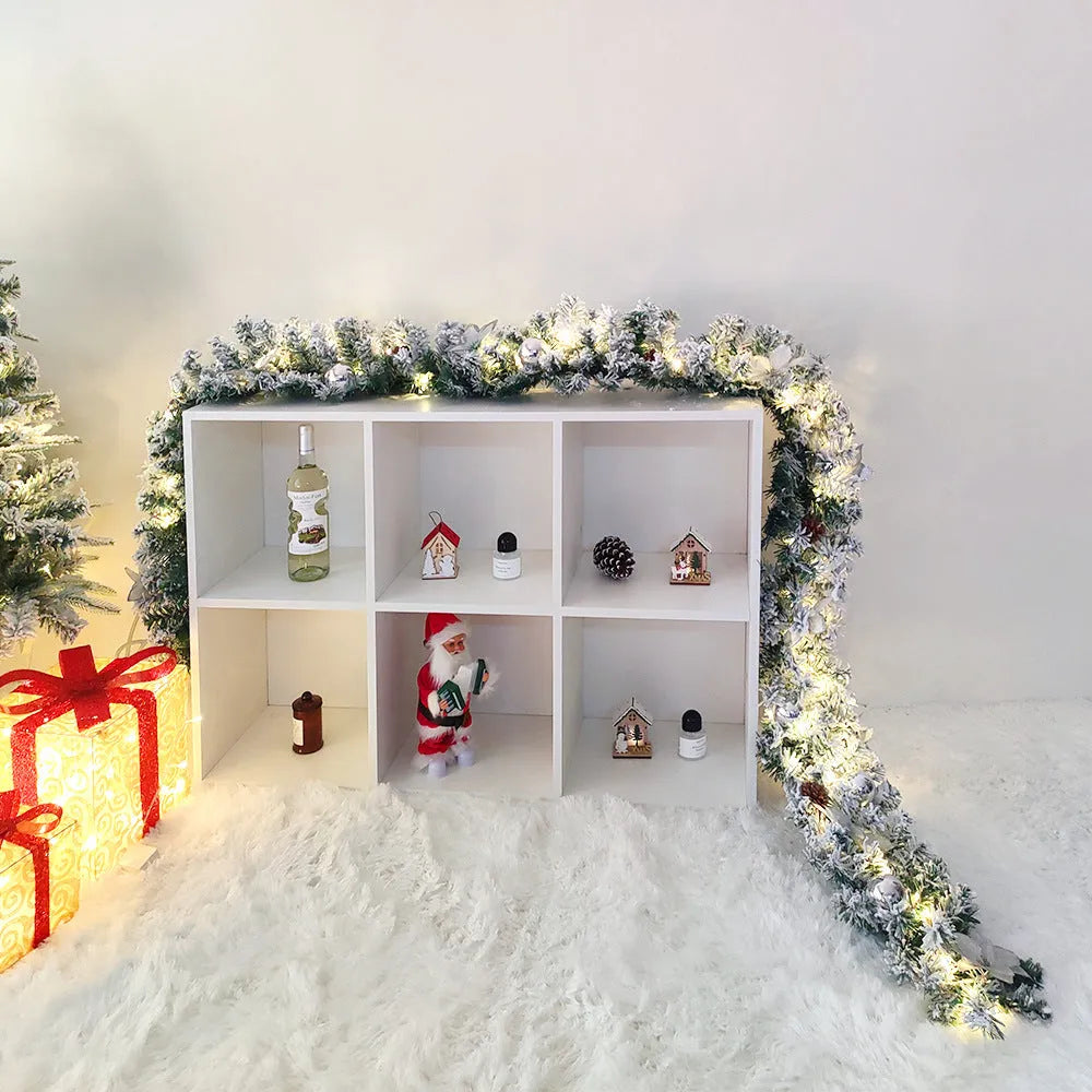 PVC rattan Christmas garland with flocked decoration in golden colour, draped along a mantle