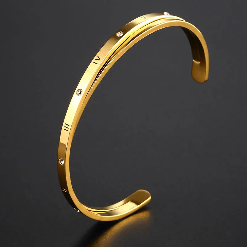 Open-ended stainless steel ladies bracelet with a love symbol and zircon detail, shown in rose gold finish.