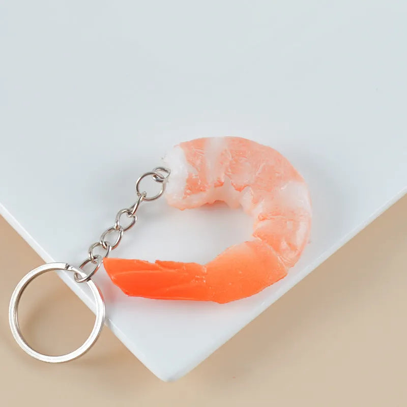 Realistic PVC shrimp-shaped keychain with door buckle attachment, shown against a white background.