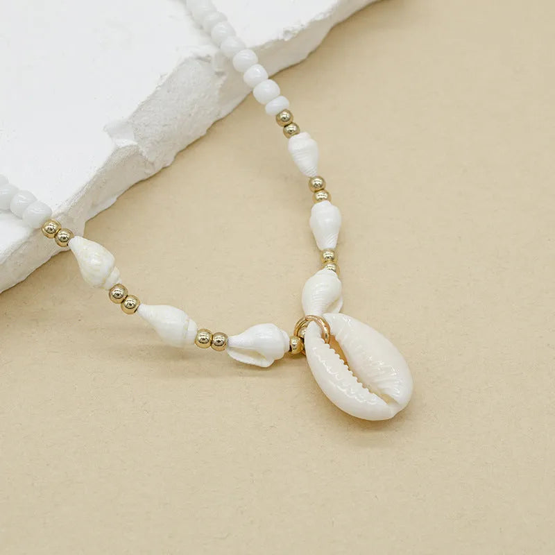 Women's white mother of pearl shell pendant necklace with regular chain on display