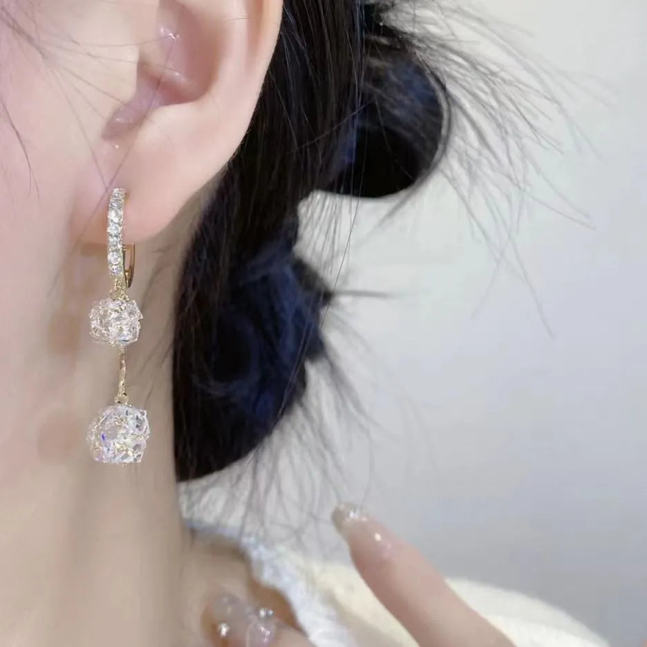Silver tone clip-on earrings with tassel ball and rhinestone ball pendants in drop design