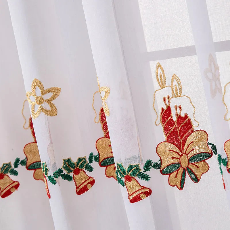 A pair of white polyester curtains with embroidered red and green snowflakes, showing American Christmas style.