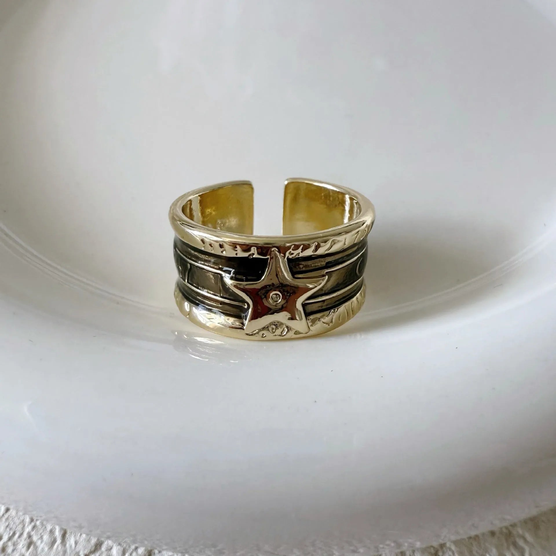 Adjustable geometric drop oil ring in distressed copper, shown in multiple colour options.