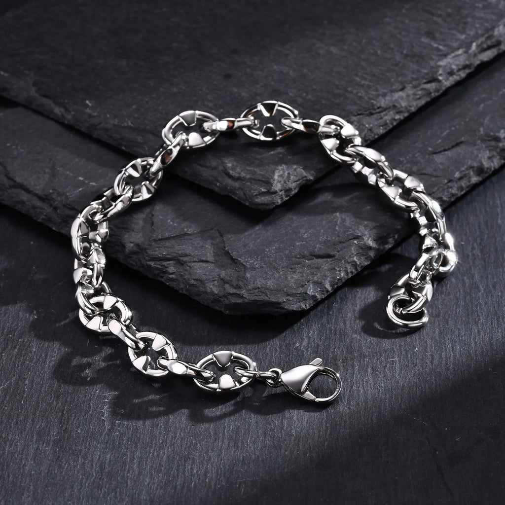 Stainless steel thick geometric chain bracelet on a wrist, showing handmade links and steel colour finish.