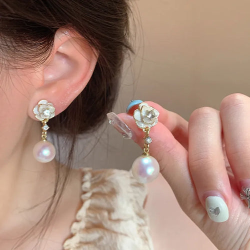 Camellia flower shaped stud earrings in alloy metal with floral design details