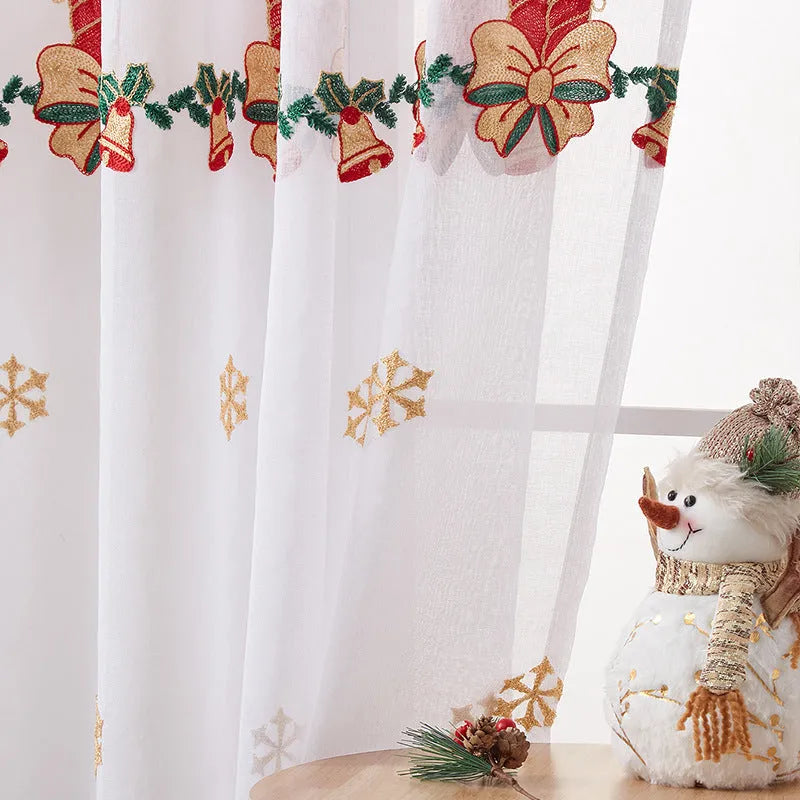A pair of white polyester curtains with embroidered red and green snowflakes, showing American Christmas style.