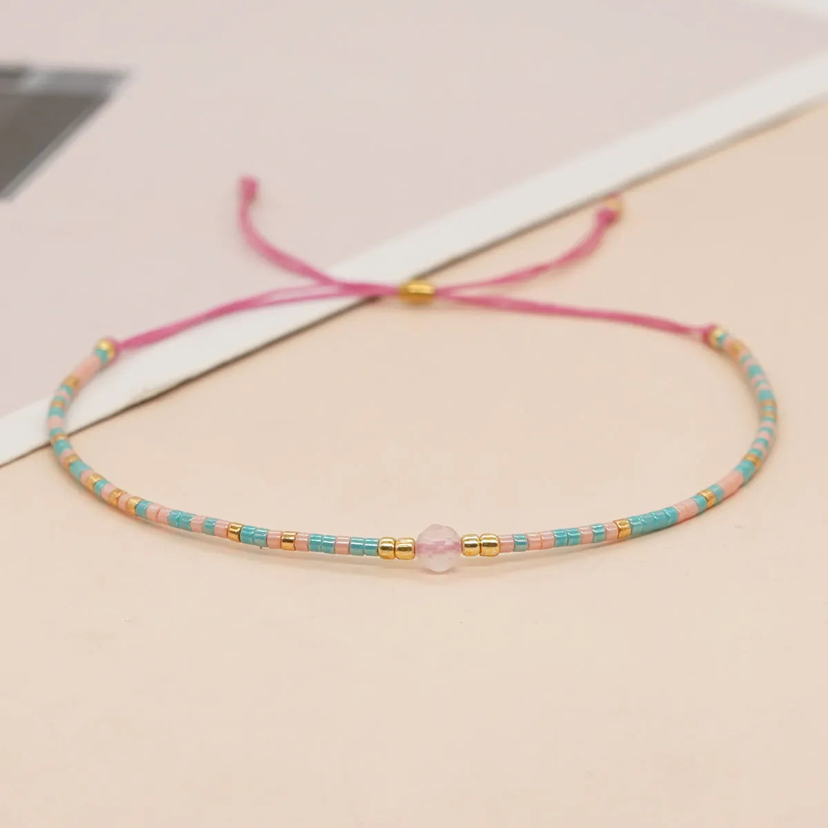 A colourful Bohemian style beaded bracelet with semi-precious stone and glass beads on an adjustable strap.