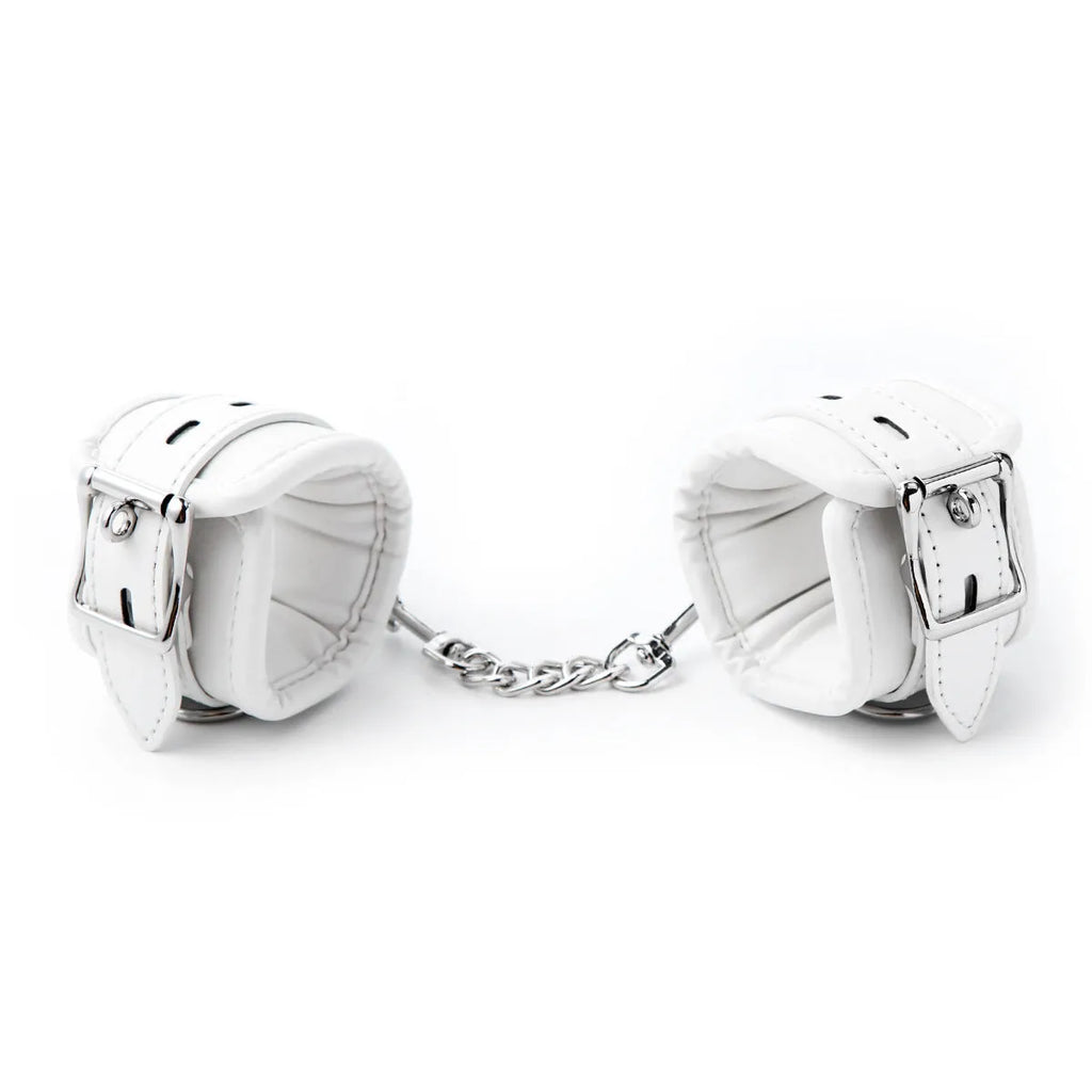 White PU sponge bondage set showing soft handcuffs, an ankle cuff, and a neck restraint.