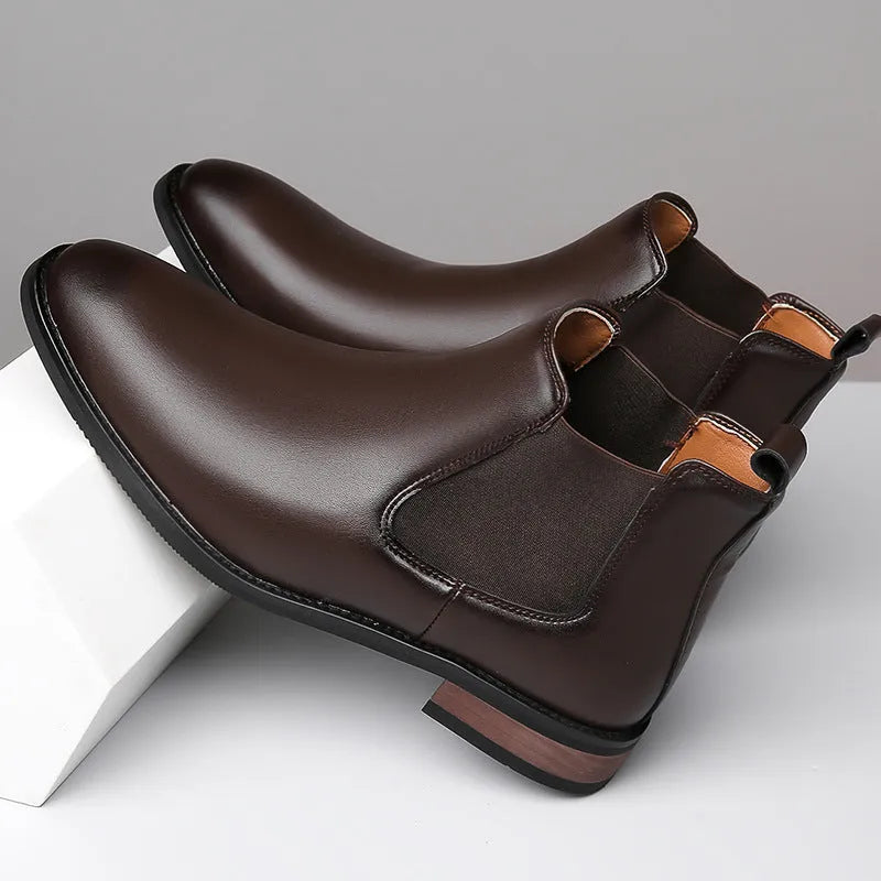 Men's black pointed toe Chelsea boots with a round toe shape and rubber sole.