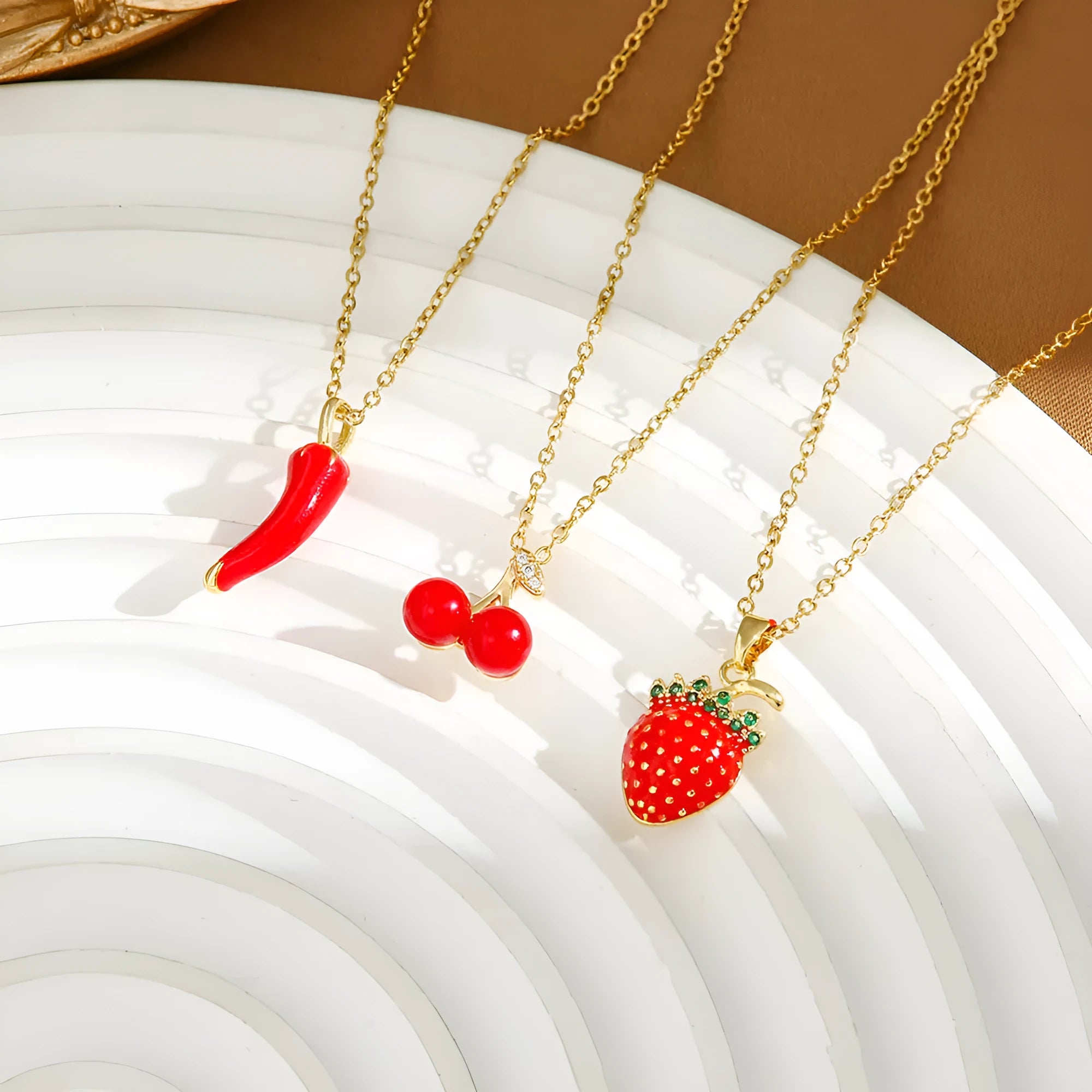 Women's titanium steel necklace with delicate indie pendant designs including strawberry, cherry, and pepper motifs