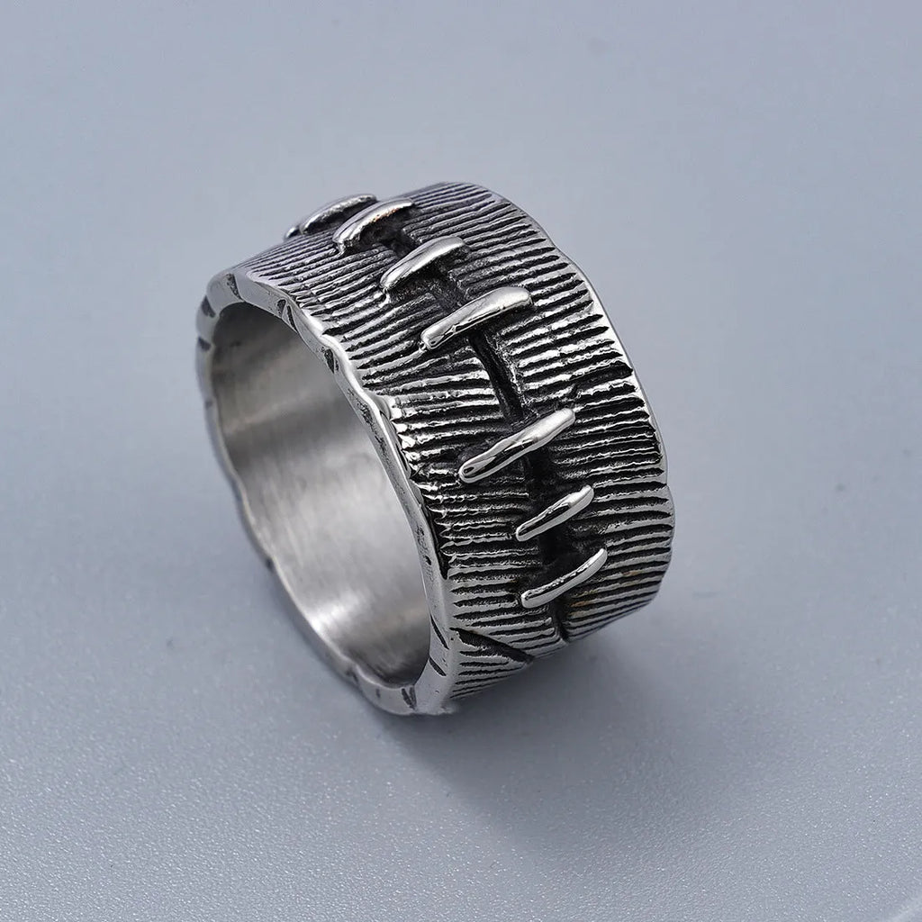 Geometric dark punk titanium steel double ring in retro colour, showing stitched design on a hand.