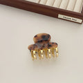 A medium-size retro-style hair barrette with a metal grip, in an alloy acrylic construction.