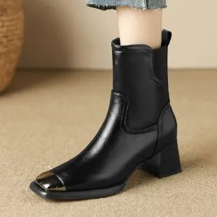 Brown cowhide leather Martin boots with side zip and high heel on wooden floor