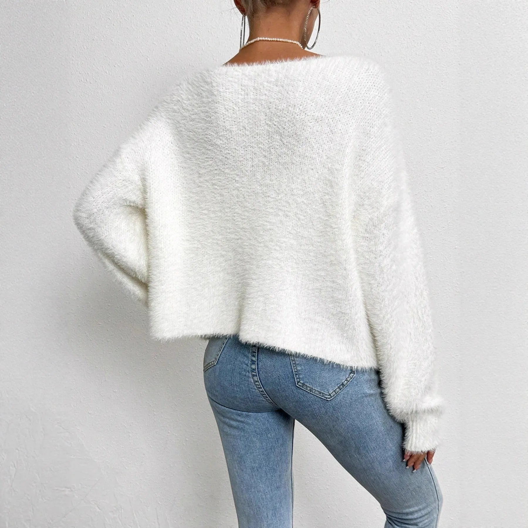 White women's cardigan sweater with V-neck design and beaded knitwork detailing