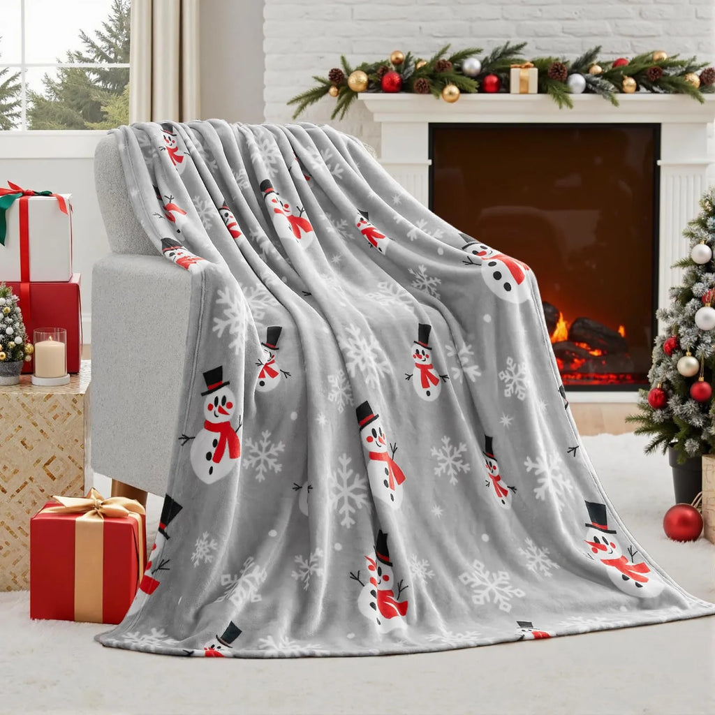 Soft red flannel Christmas blanket draped over a bed corner